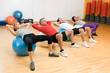 Exercising with fitness ball at gym