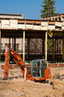 Small orange excavator on construction site