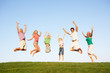Photos : Young couple with grandparents and children jump in a field