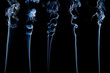 five different separate wisps of smoke on black;