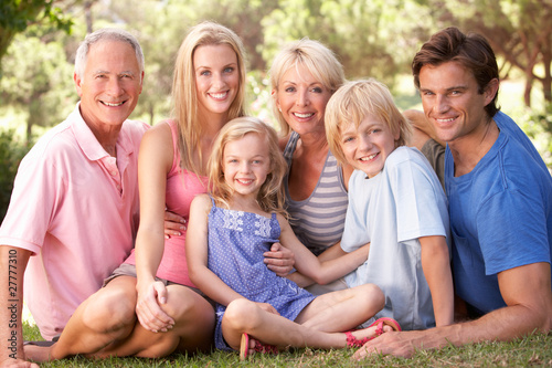 Photo: A family, with parents, children and grandparents, relaxing in a A family, with parents, children and grandparents, relaxing in a