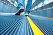 Foot move in airport escalator