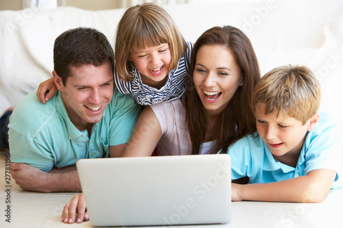Photo: Young parents, with children, on laptop computer Young parents, with children, on laptop computer