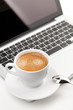 Cappuccino cup on laptop Cappuccino cup on laptop
