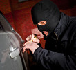 robber and the thief in a mask hijacks the car