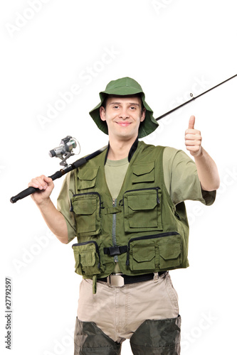 Photo: A happy fisherman with fishing pole giving thumbs up A happy fisherman with fishing pole giving thumbs up