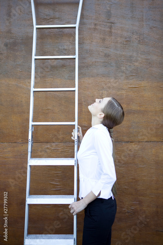 Photo: Woman climbing career ladders Woman climbing career ladders