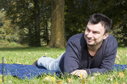 Photo: Young Adult Relaxing in the Park Young Adult Relaxing in the Park