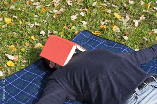 Photo: Young Adult Relaxing in the Park Young Adult Relaxing in the Park
