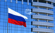 Russian flag on the background of the windows of office building Russian flag on the background of the windows of office building