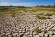 Photo: Dried and cracked soil under blue sky Dried and cracked soil under blue sky