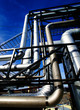 Industrial zone, Steel pipelines and valves against blue sky Industrial zone, Steel pipelines and valves against blue sky