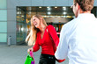 Woman dragging man into shopping mall Woman dragging man into shopping mall