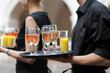 Waiter with dish of wine and juice glasses Waiter with dish of wine and juice glasses