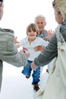 Foto: Young Boy is running from grandfather's stretched Arms Young Boy is running from grandfather's stretched Arms