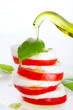 Fresh salad with mozzarella, tomato and basil with olive oil pou Fresh salad with mozzarella, tomato and basil with olive oil pou