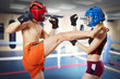 Two person training kikboxing on ring