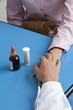 Closeup of doctor's hand holding patient's hand with medicine on table