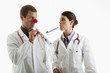 Male and female doctors with party toys