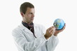 Doctor holding stethoscope to globe