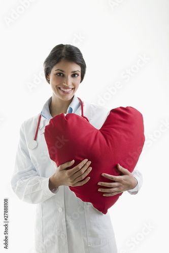 Photo: Doctor holding heart pillow Doctor holding heart pillow