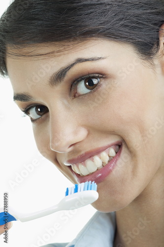 Photo: Young woman holding toothbrush Young woman holding toothbrush