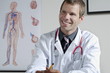 Doctor in his office with circulatory system chart on wall