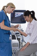 Technician using ultrasound treatment on patients wrist