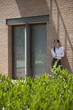Young woman smoking a cigarette outside building