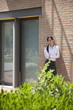 Young woman smoking a cigarette outside building