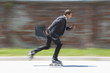 Businessman in suit inline skating