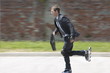 Businessman in suit inline skating