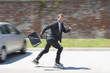 Businessman in suit inline skating