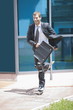 Businessman in suit inline skating
