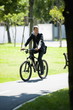 Photo: Businessman in suit riding bike Businessman in suit riding bike