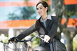 Photo: Woman in suit on bicycle Woman in suit on bicycle