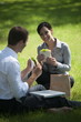 Business people eating lunch on grass