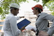 Man and woman with hardhats at construction site