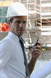 Man with hardhat and walky talky radio at construction site