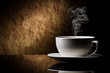 cup of coffee with cinnamon on a old stone background.