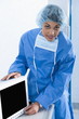Surgeon adjusting monitor in operating room