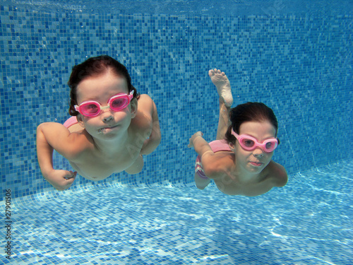 Photo: Two underwater girls in swimming pool Two underwater girls in swimming pool