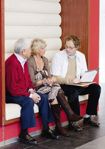 Photo: A senior couple talking to a medical consultant A senior couple talking to a medical consultant