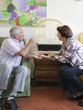 A senior couple discussing a bird in a cage
