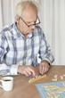 A senior man playing a board game