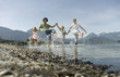 A family paddling in a lake, kicking the water