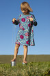 A girl playing outside on tin can stilts
