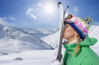 Woman kissing skis on snowy mountain