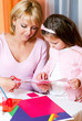 Mother and the daughter сut figures from a colour paper