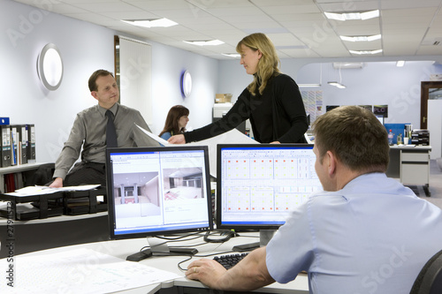 Photo: CAD designers and architects working in office CAD designers and architects working in office